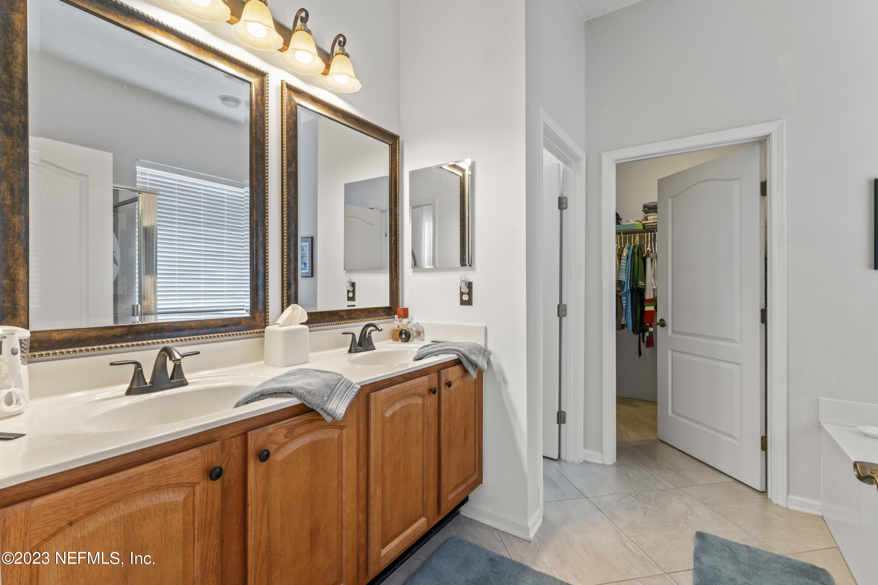 1840 Copper Stone Drive, Unit D Fleming Island, FL 32003 - Photo 19 of 66 a bathroom with a sink double vanity and a mirror