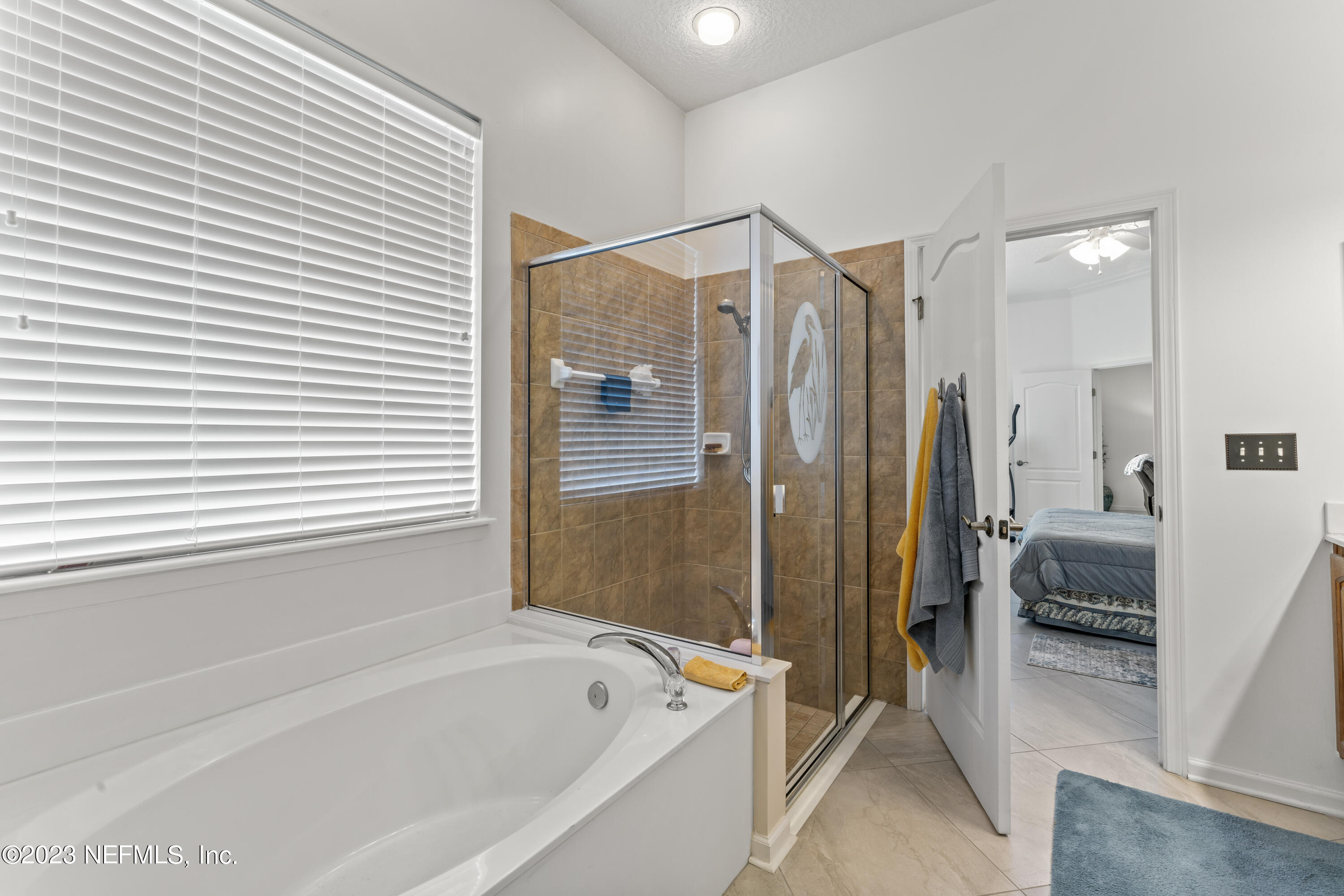1840 Copper Stone Drive, Unit D Fleming Island, FL 32003 - Photo 20 of 66 a bathroom with a tub a shower and a sink