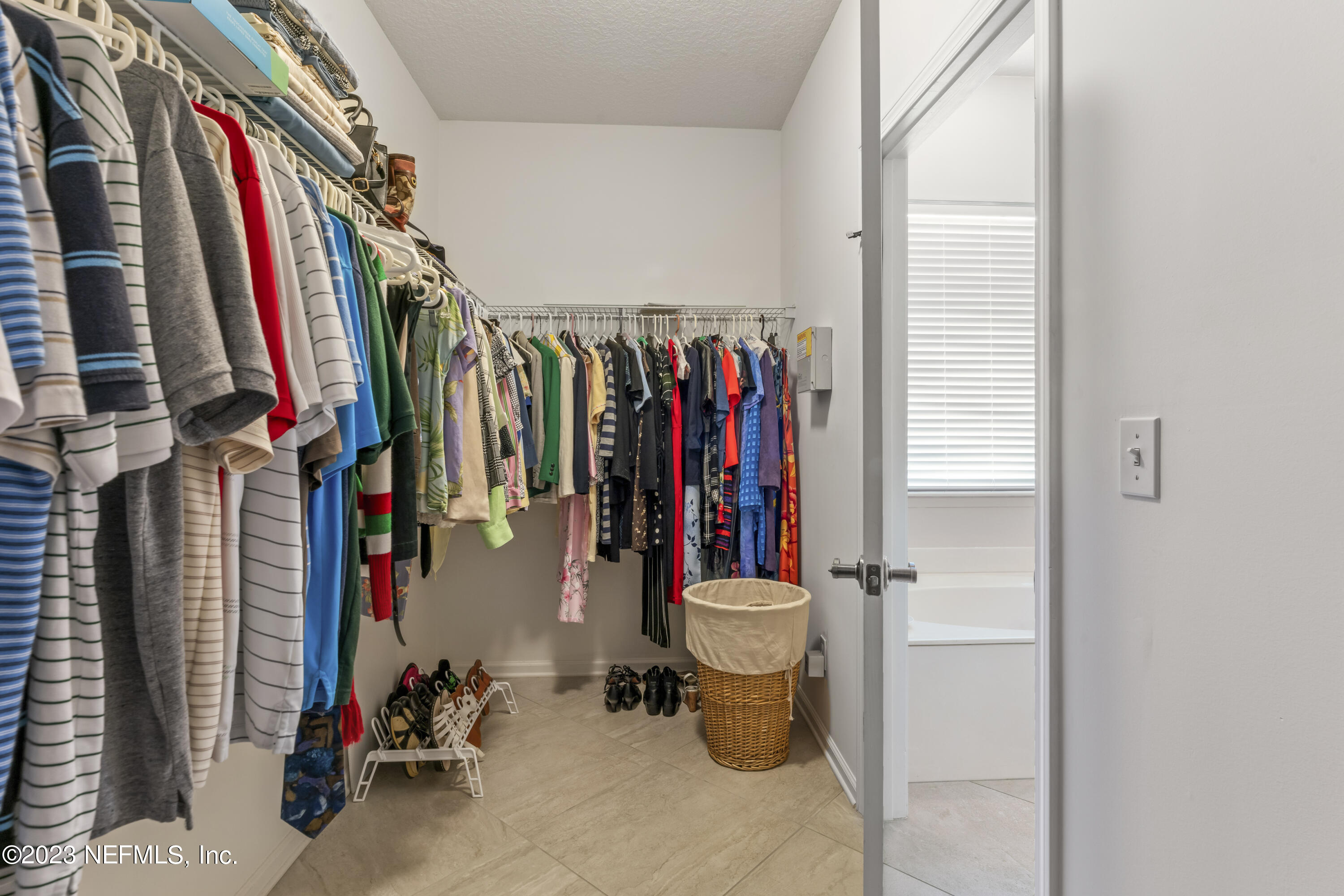 1840 Copper Stone Drive, Unit D Fleming Island, FL 32003 - Photo 21 of 66 a view of walk in closet with clothes and shoes