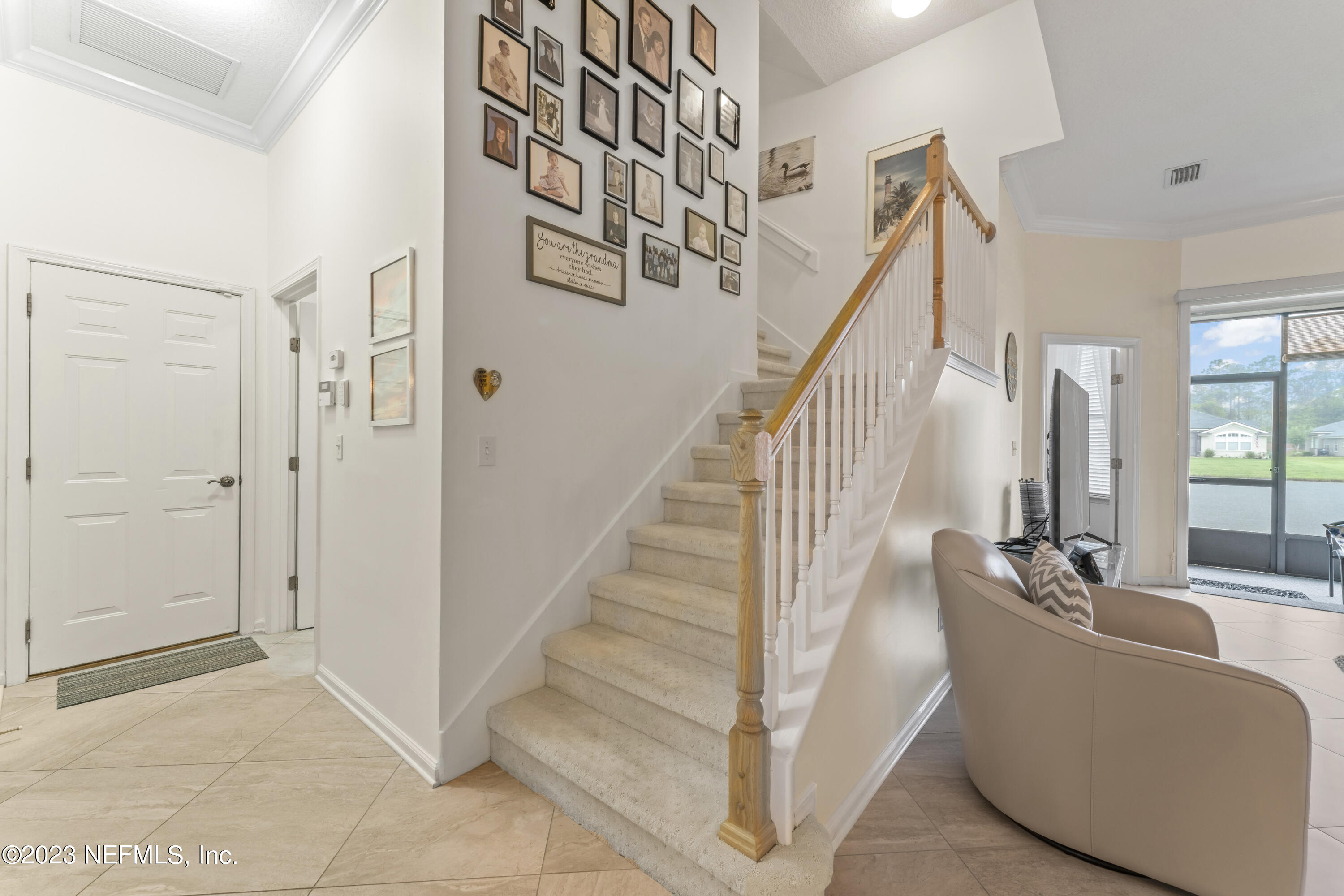 1840 Copper Stone Drive, Unit D Fleming Island, FL 32003 - Photo 24 of 66 a living room with wooden floor and stairs