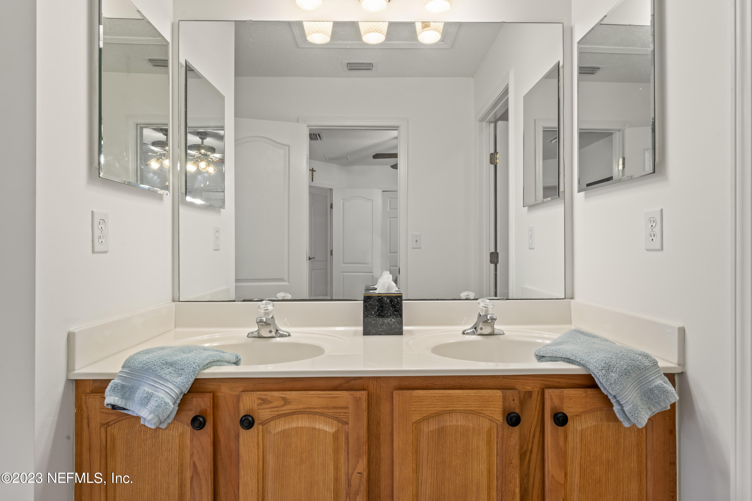 1840 Copper Stone Drive, Unit D Fleming Island, FL 32003 - Photo 28 of 66 a bathroom with a sink and a mirror