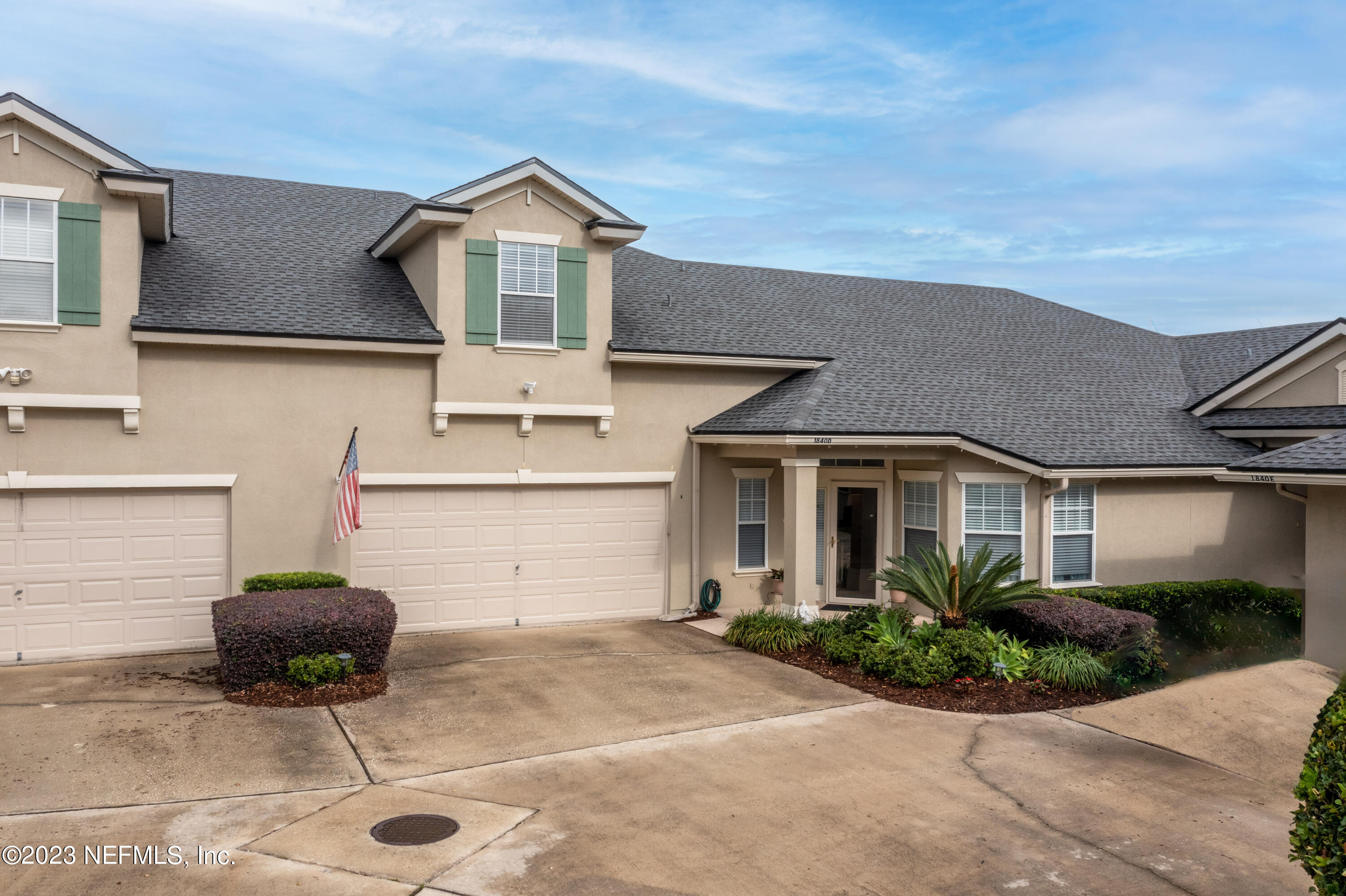 1840 Copper Stone Drive, Unit D Fleming Island, FL 32003 - Photo 50 of 66 a front view of a house with garden