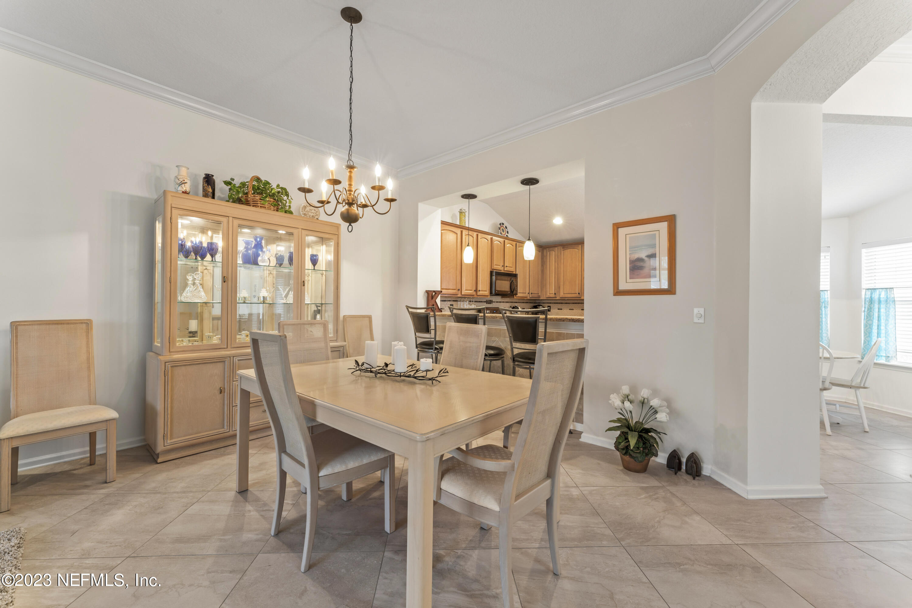 1840 Copper Stone Drive, Unit D Fleming Island, FL 32003 - Photo 5 of 66 a view of a dining room with furniture and a chandelier