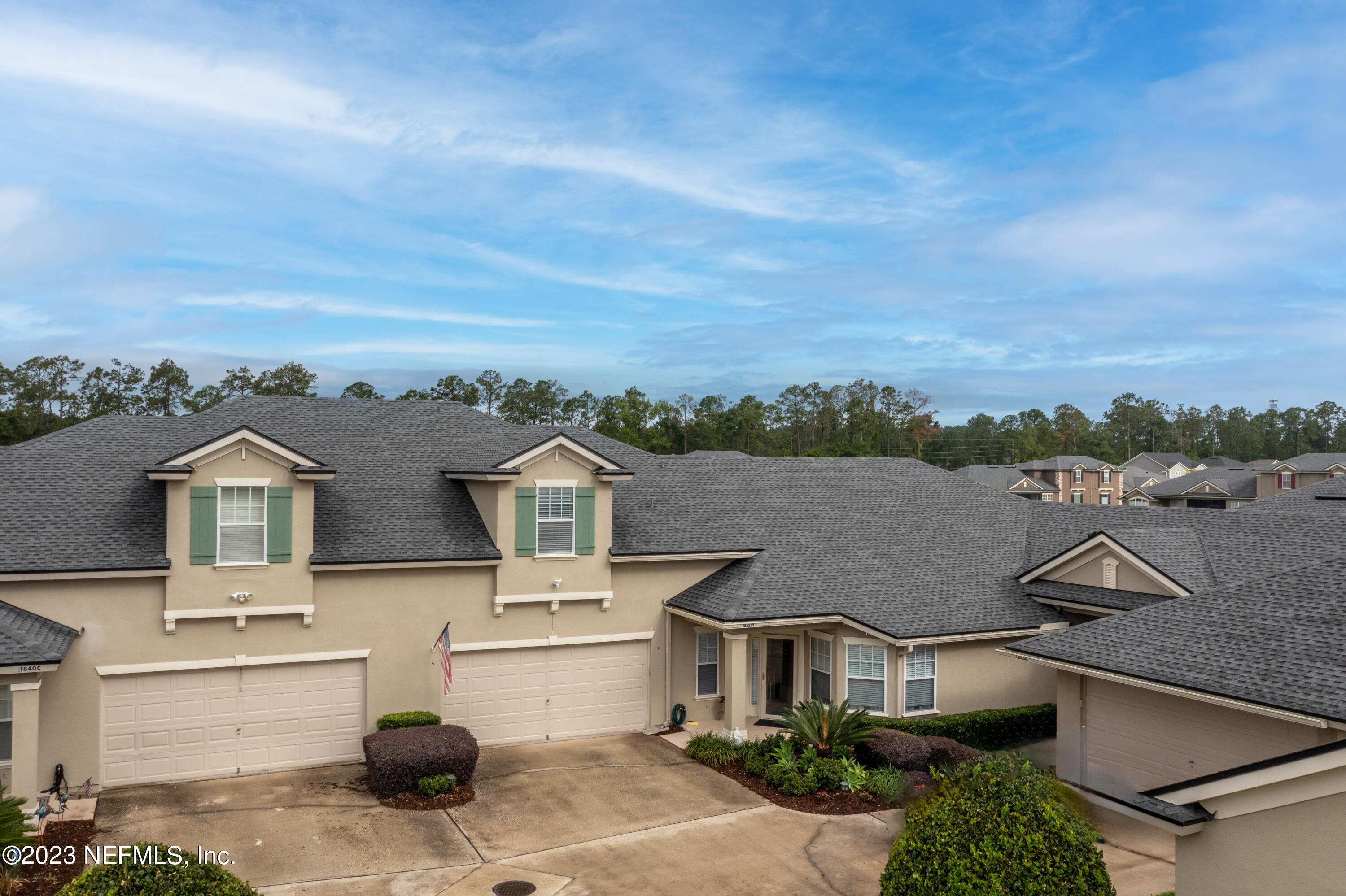 1840 Copper Stone Drive, Unit D Fleming Island, FL 32003 - Photo 52 of 66 a aerial view of a house with a yard and garage