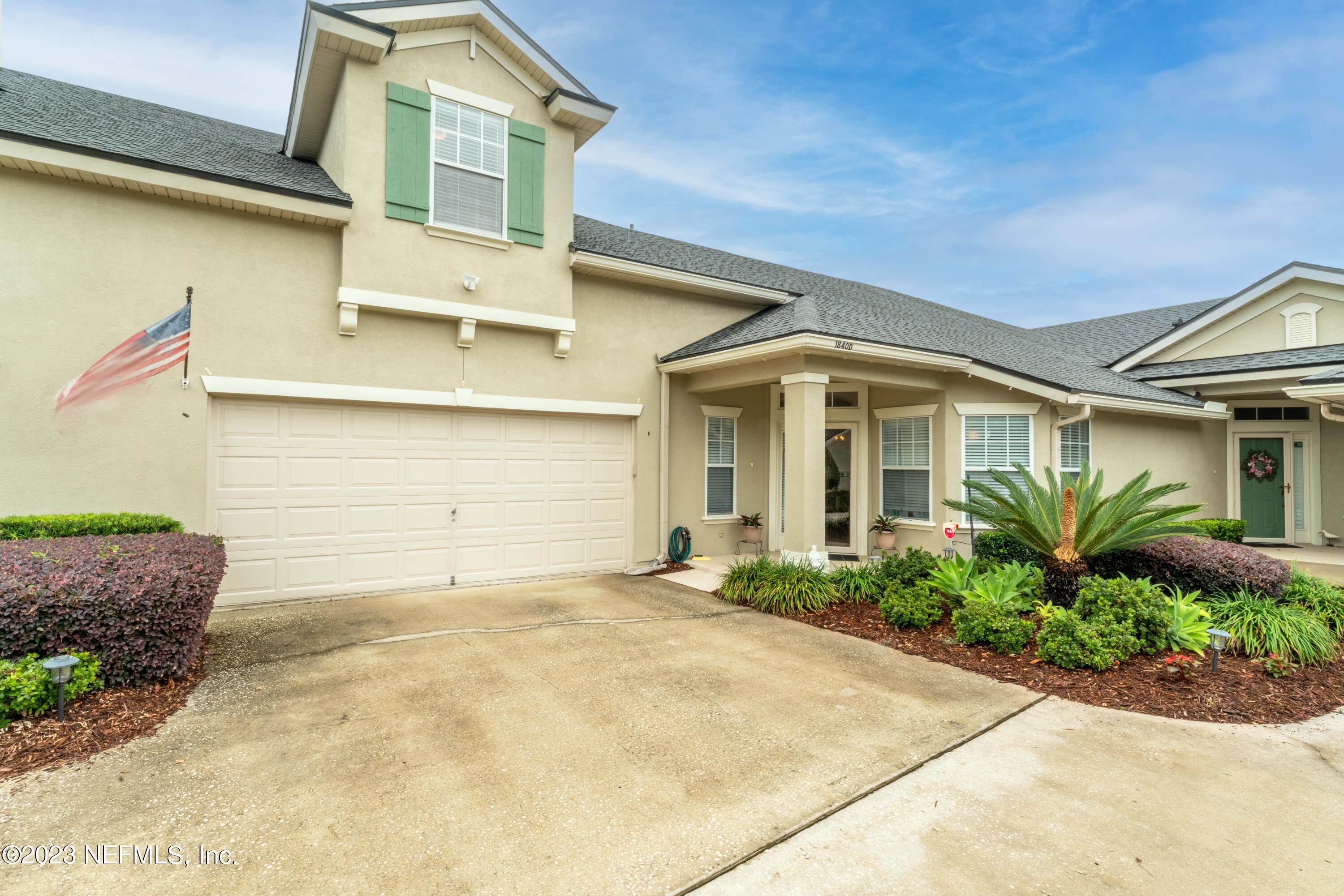 1840 Copper Stone Drive, Unit D Fleming Island, FL 32003 - Photo 53 of 66 a front view of a house with a yard