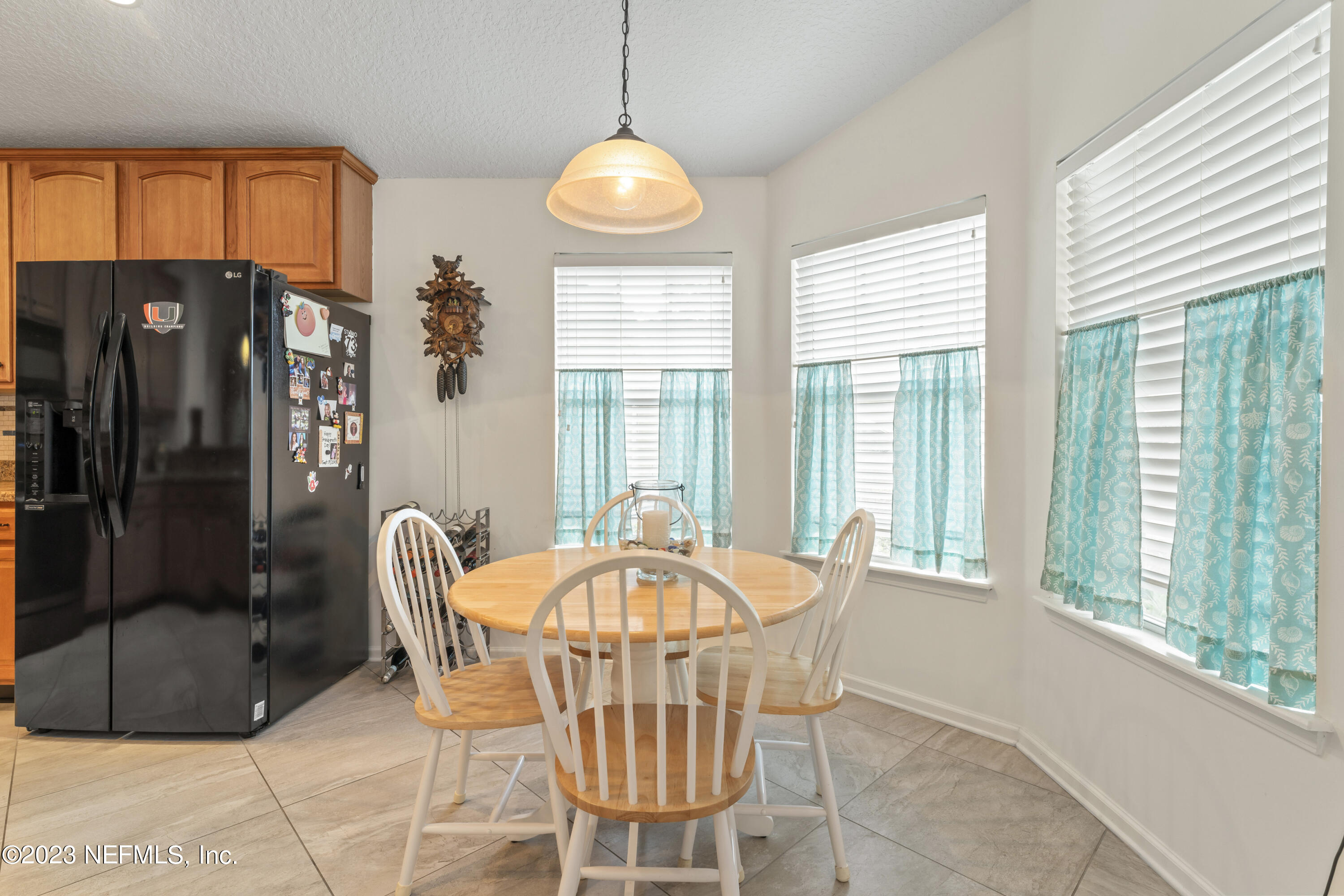 1840 Copper Stone Drive, Unit D Fleming Island, FL 32003 - Photo 57 of 66 a dining room with furniture a chandelier and window