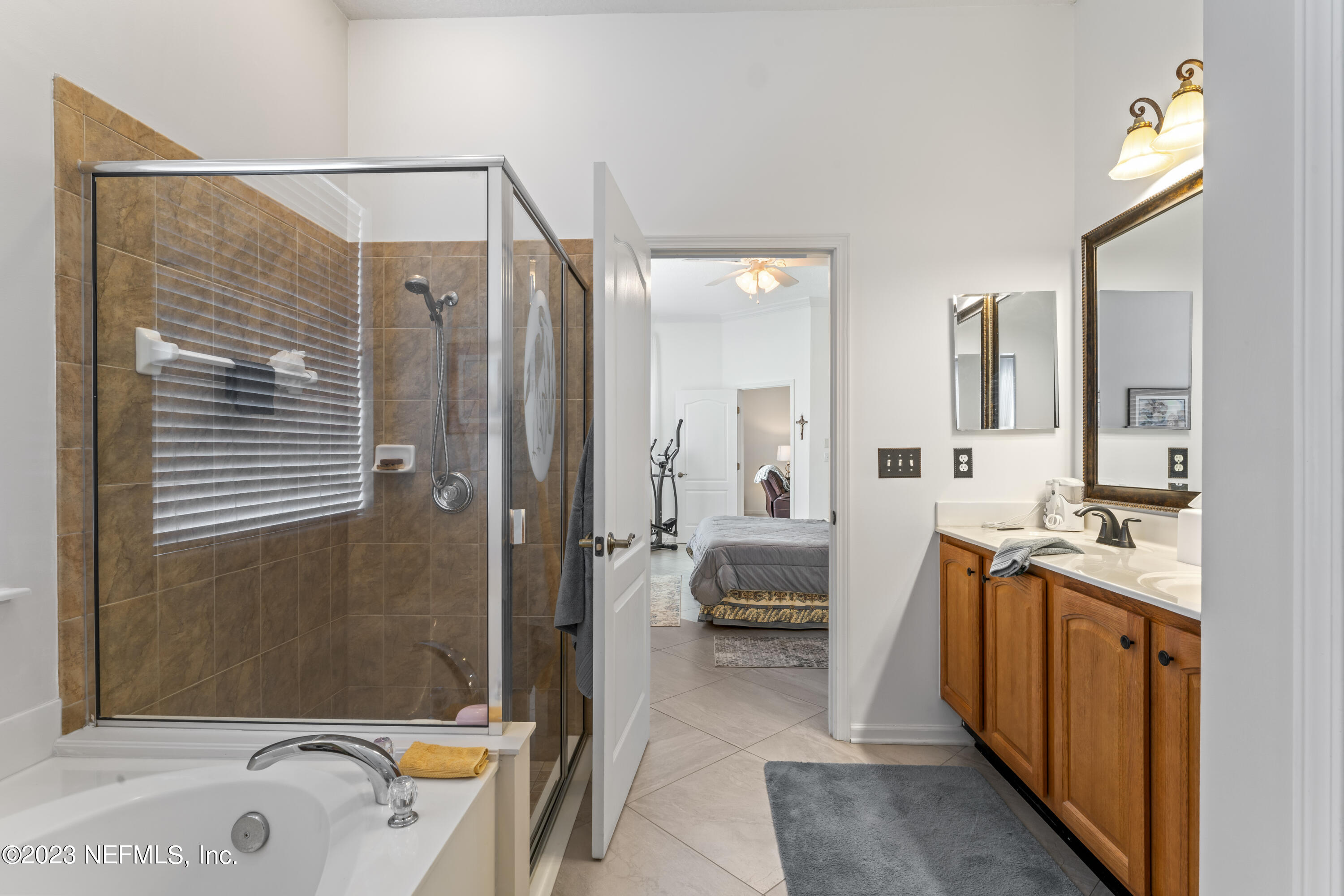 1840 Copper Stone Drive, Unit D Fleming Island, FL 32003 - Photo 58 of 66 a en suite spacious bathroom with a tub sink and mirror