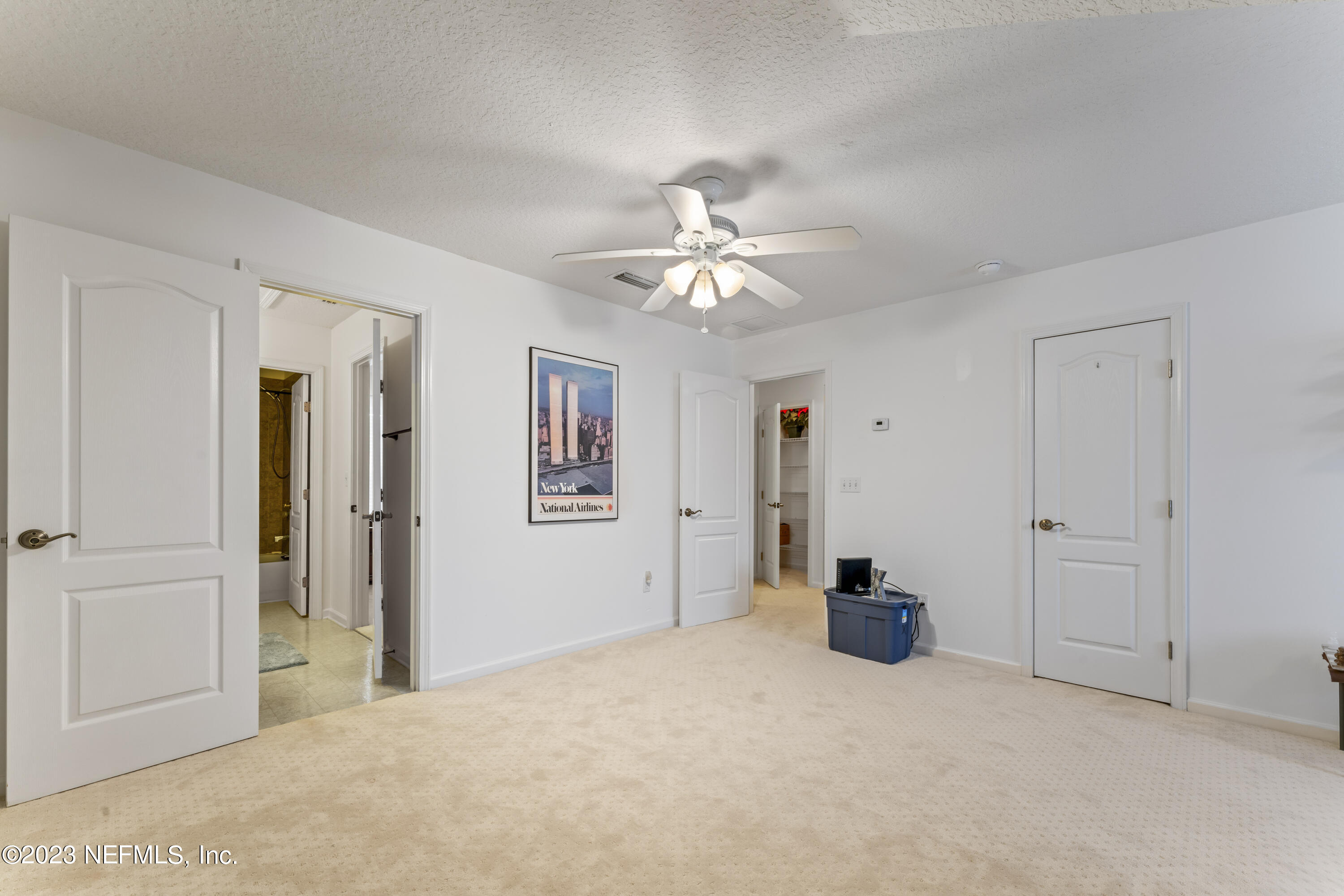 1840 Copper Stone Drive, Unit D Fleming Island, FL 32003 - Photo 59 of 66 a living room with a hallway and a chandelier