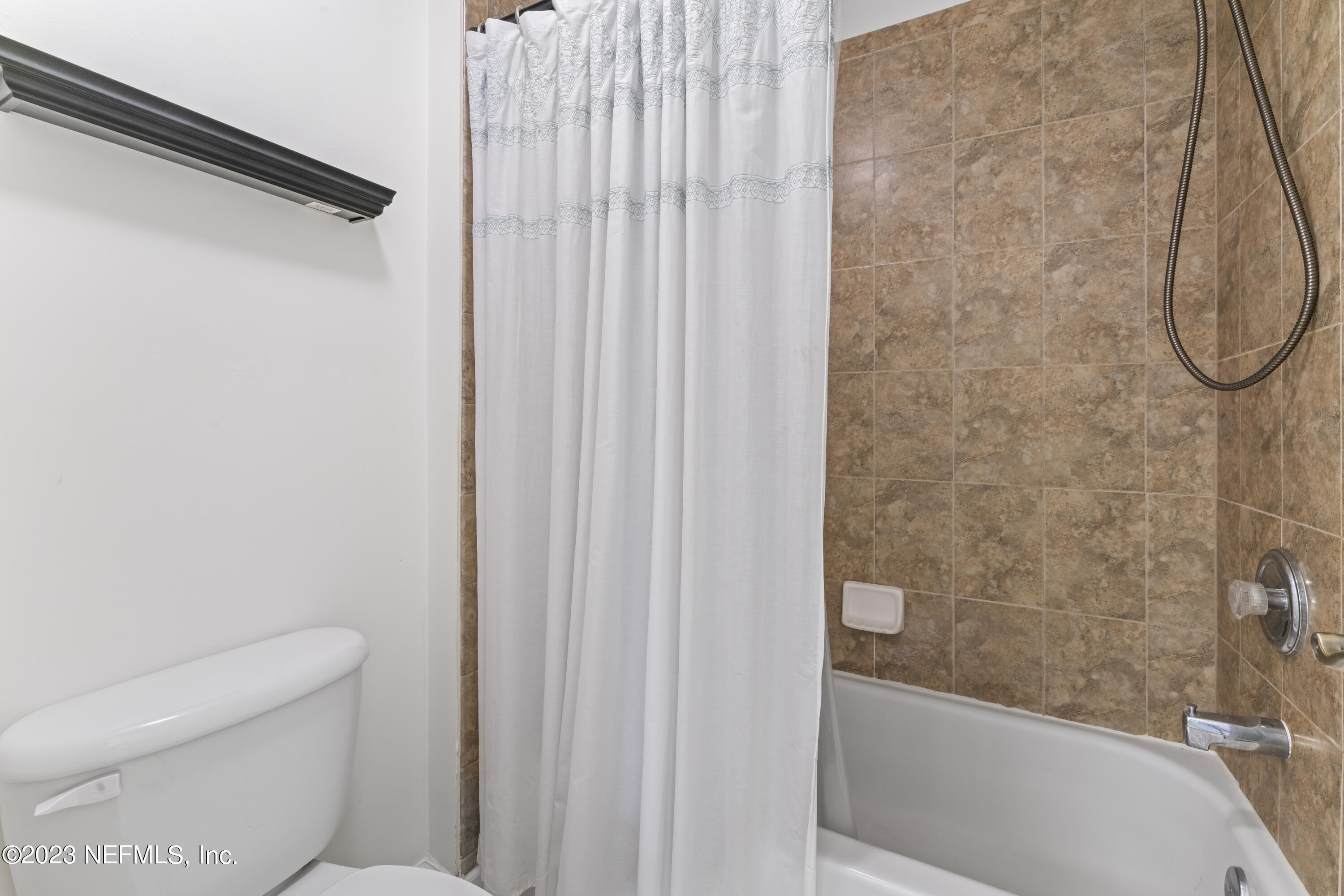 1840 Copper Stone Drive, Unit D Fleming Island, FL 32003 - Photo 60 of 66 a bathroom with a toilet and a bathtub