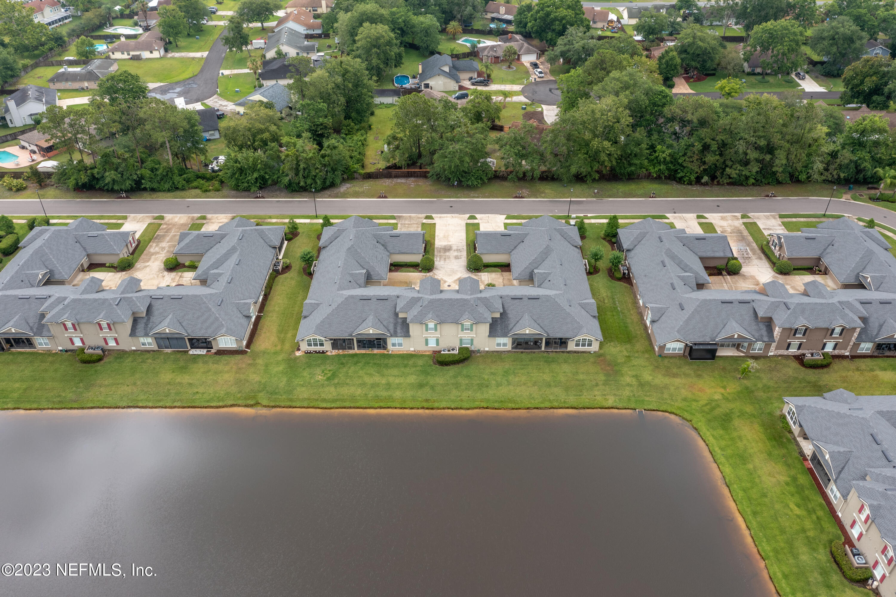 1840 Copper Stone Drive, Unit D Fleming Island, FL 32003 - Photo 62 of 66 a view of a swimming pool with a yard