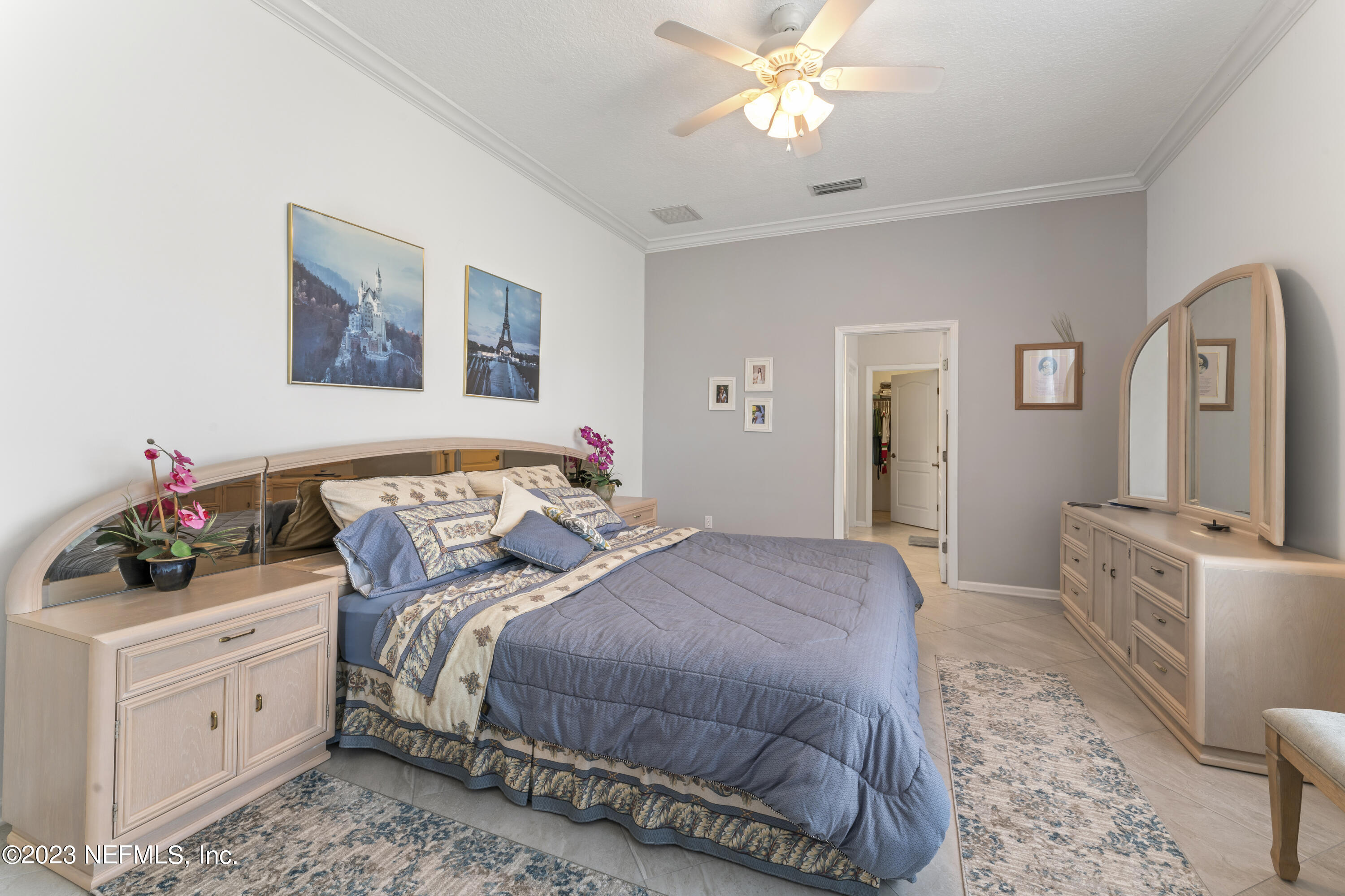 1840 Copper Stone Drive, Unit D Fleming Island, FL 32003 - Photo 7 of 66 a bedroom with a bed and a dresser