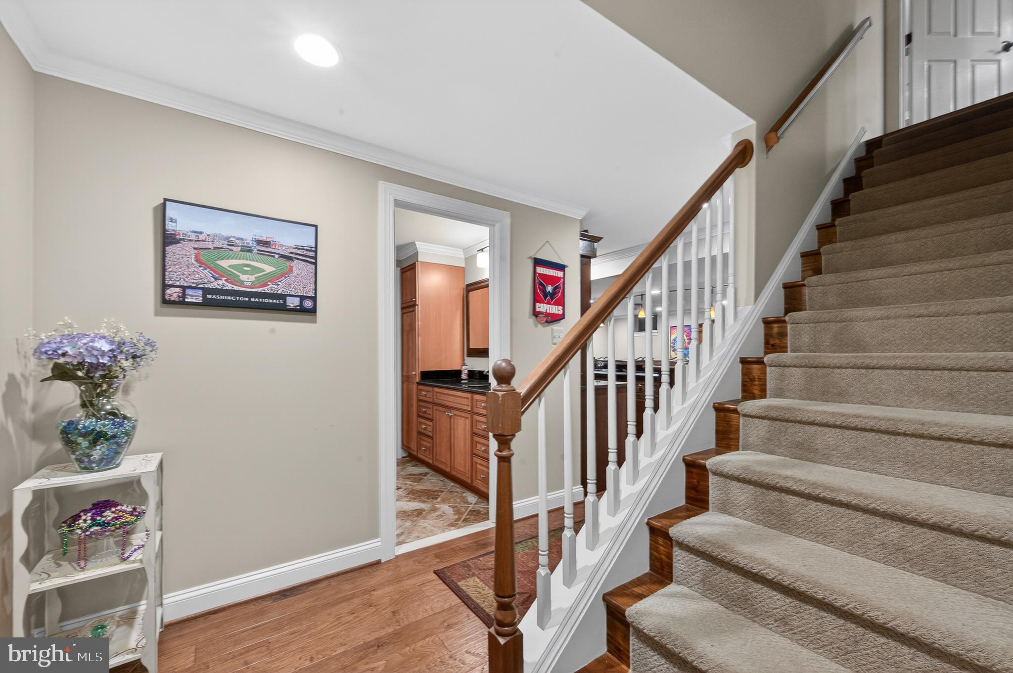 6601 Colchester Road Fairfax Station, VA 22039 - Photo 51 of 78 a view of staircase with wooden floor and a potted plant