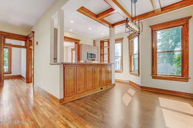 a view of an entryway with wooden floor and windows