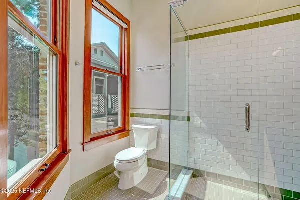 a bathroom with a toilet and a shower