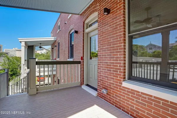 a view of a brick house with a large window