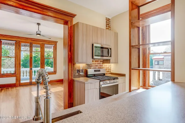 a kitchen with a stove a sink and a refrigerator