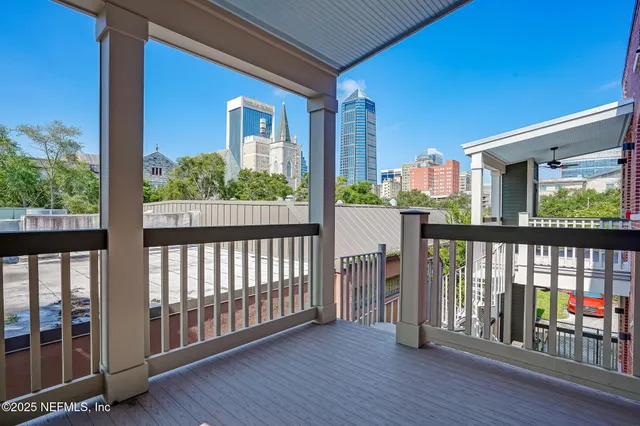 a view of a porch with wooden floor and outdoor seating