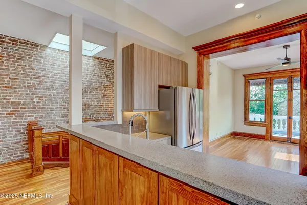 a view of kitchen with furniture and refrigerator