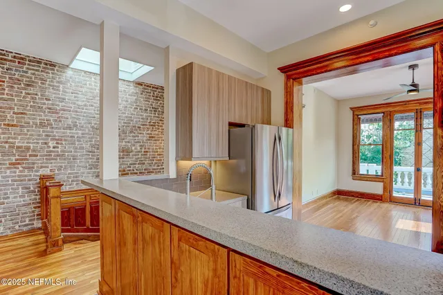 a view of kitchen with furniture and refrigerator