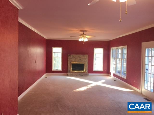 894 Graves Mill Road Madison, VA 22727 - Photo 24 of 40 a view of an empty room with a fireplace and a window