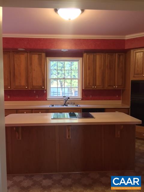 894 Graves Mill Road Madison, VA 22727 - Photo 28 of 40 a kitchen with stainless steel appliances wooden cabinets and a counter top