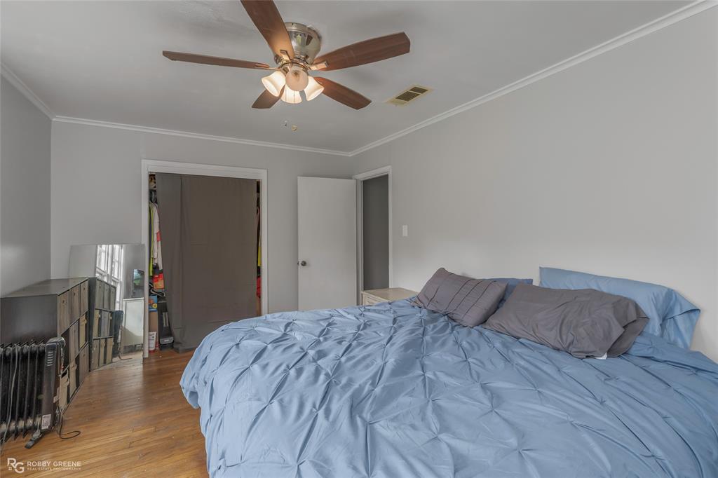 5725 Harper Road Keithville, LA 71047 - Photo 14 of 35 a bedroom with a bed and a chandelier