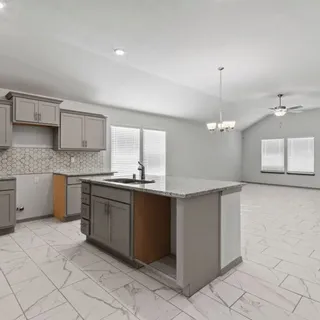 a kitchen with a stove top oven sink and cabinets