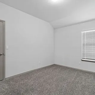 an empty room with closet area