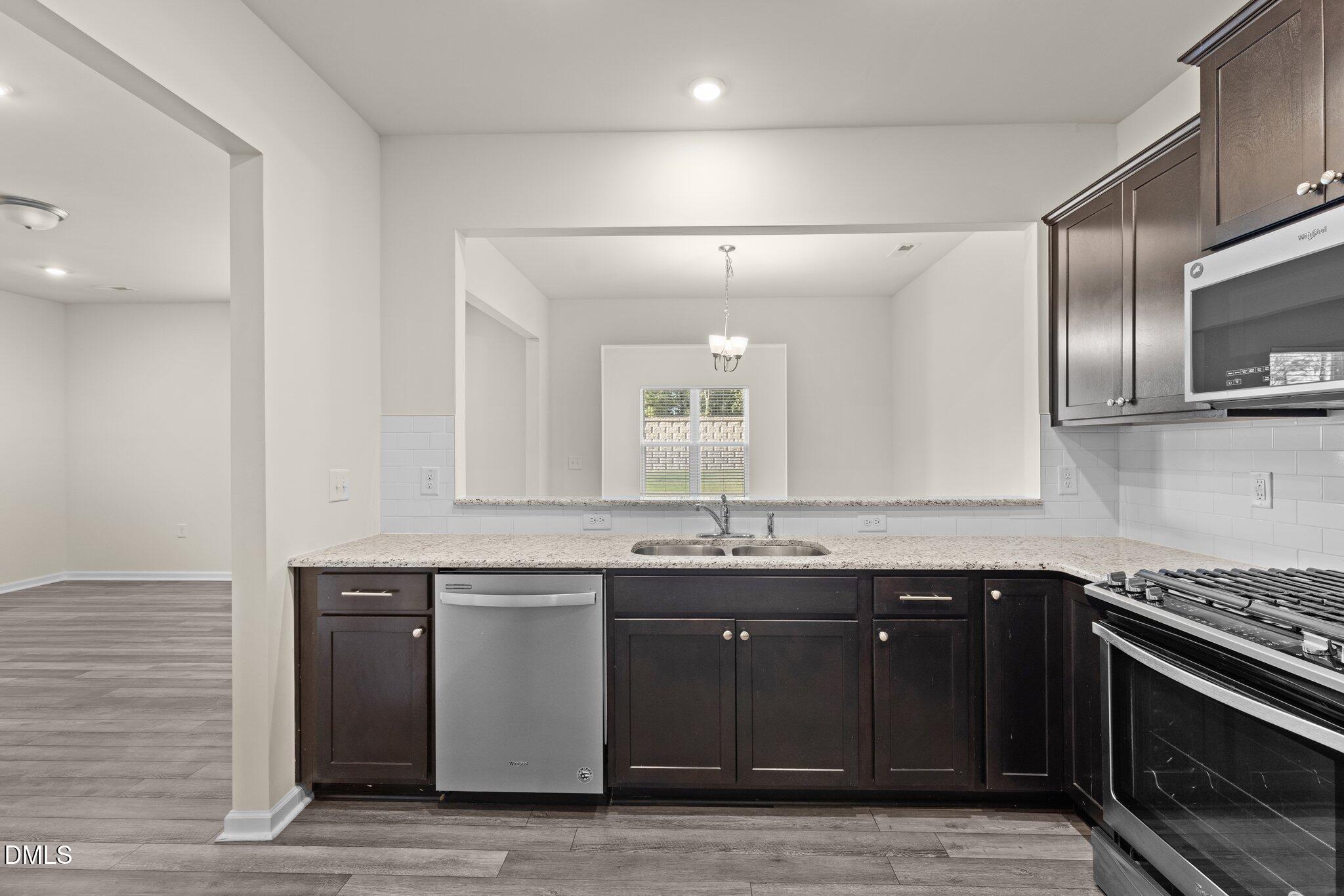 1106 Congleton Place Durham, NC 27703 - Photo 11 of 34 a kitchen with stainless steel appliances granite countertop a sink stove and cabinets