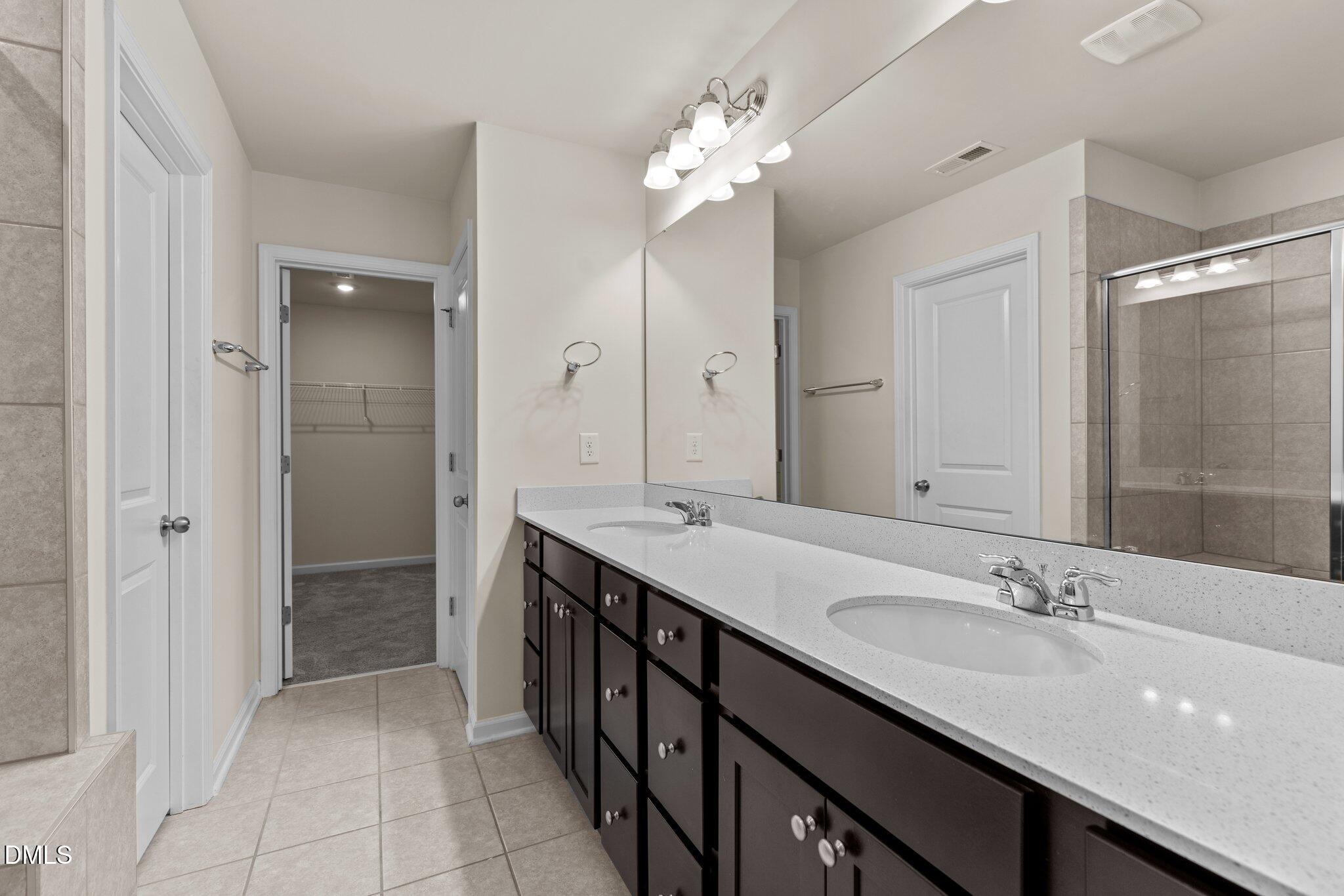 1106 Congleton Place Durham, NC 27703 - Photo 19 of 34 a bathroom with a granite countertop sink a large mirror and a shower