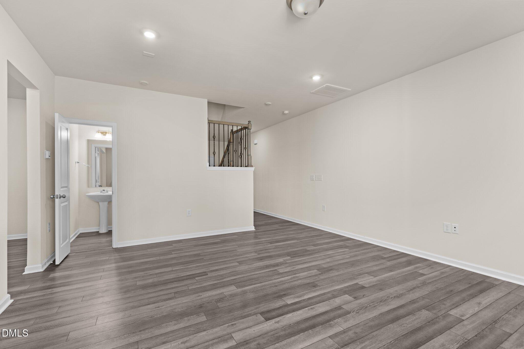 1106 Congleton Place Durham, NC 27703 - Photo 5 of 34 a view of an empty room with wooden floor and a window