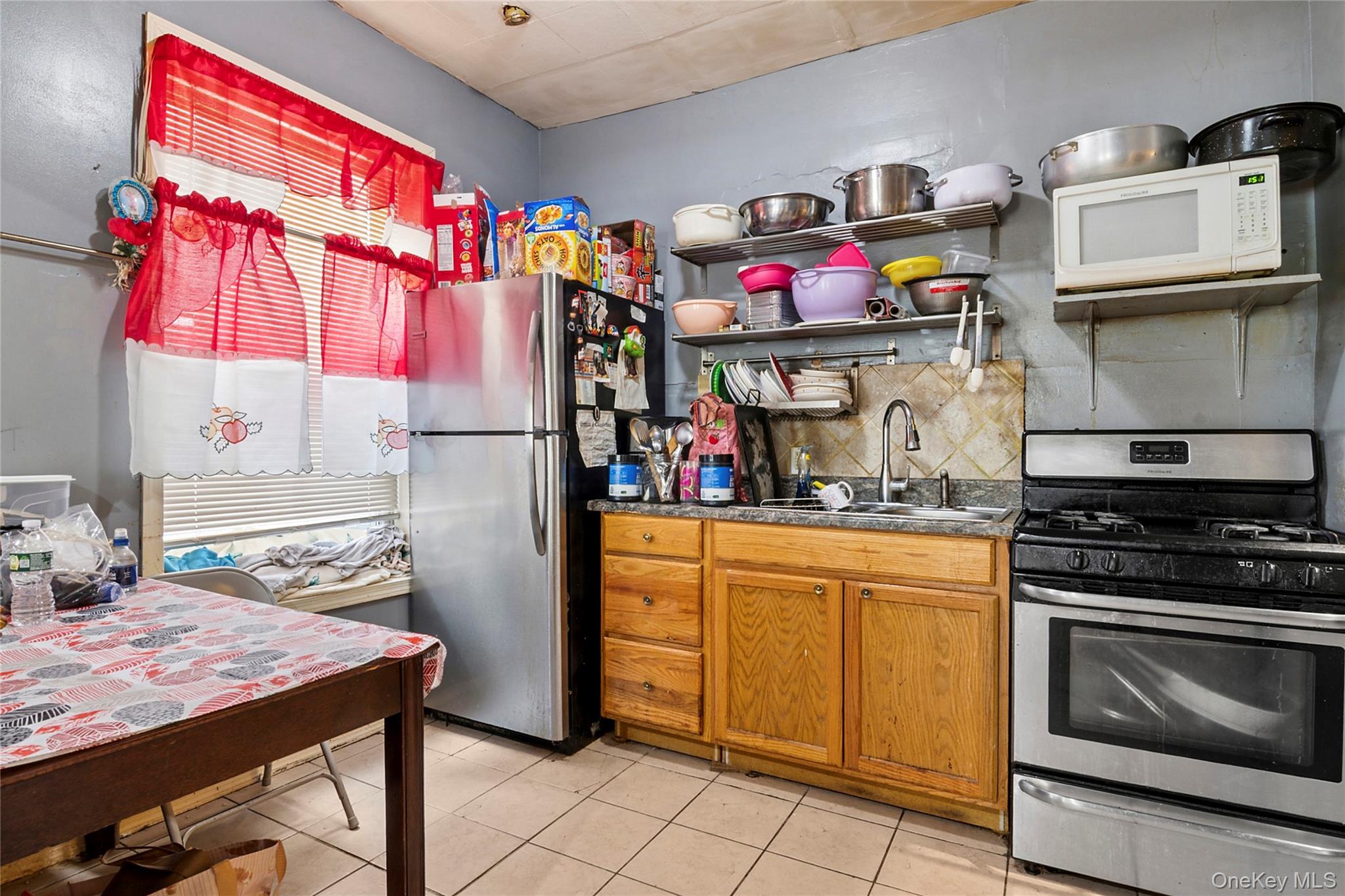 809 Friel Place Brooklyn, NY 11218 - Photo 6 of 19 a kitchen with stainless steel appliances granite countertop a sink and cabinets