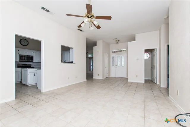 an empty room with closet and windows