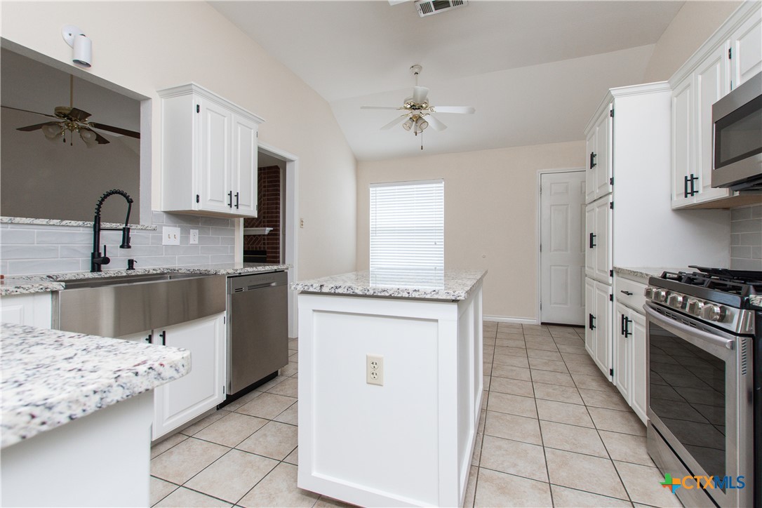 4713 Stagecoach Trail Temple, TX 76502 - Photo 8 of 23 a kitchen with stainless steel appliances granite countertop a sink stove and refrigerator