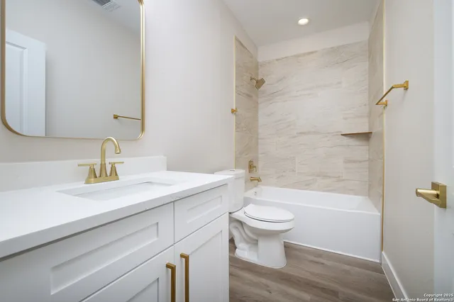 a bathroom with a sink a toilet and a mirror