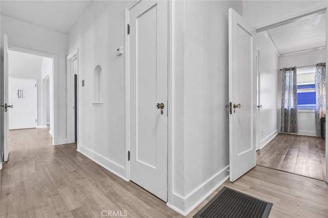 a view of a hallway with wooden floor
