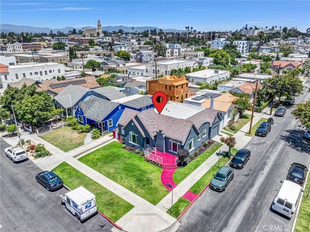 an aerial view of a house with a garden and lake view