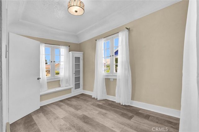 an empty room with entrance and windows