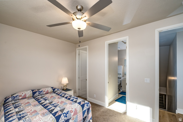 1283 North Gallen Road Santa Clara, UT 84765 - Photo 35 of 103 Bedroom 2 with a ceiling fan, light colored carpet, and en-suite bathroom