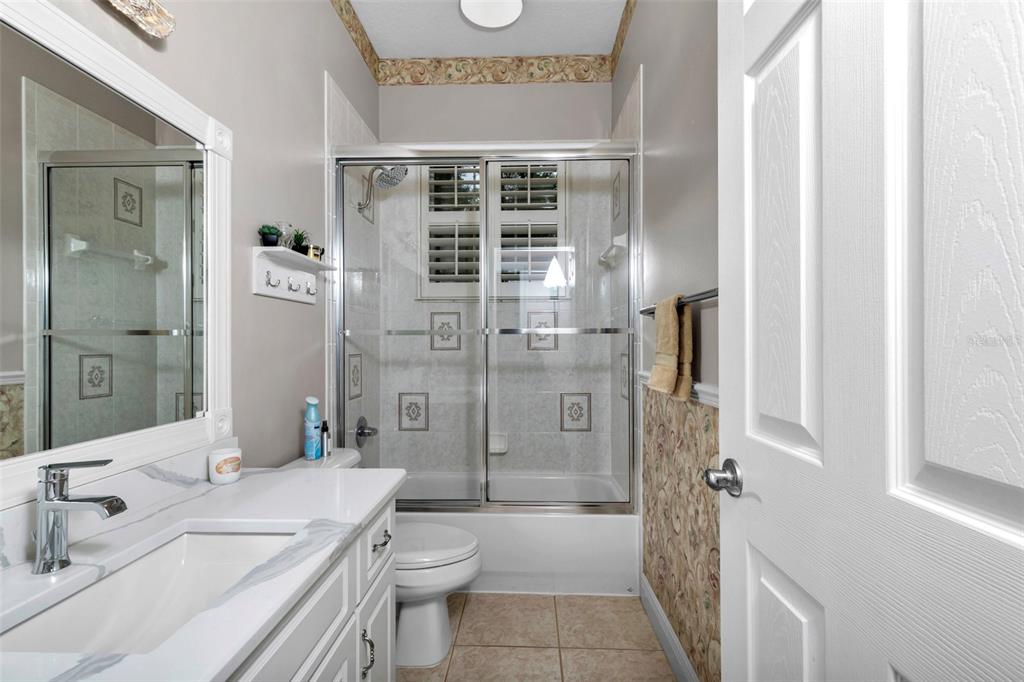 1989 Northwest 111th Loop Ocala, FL 34475 - Photo 32 of 55 a bathroom with a granite countertop sink toilet and shower