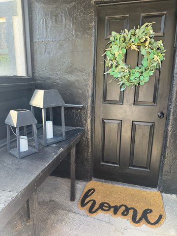 47 B Street Helper, UT 84526 - Photo 17 of 19 Dark paneled entry door with black hardware, complementing the textured black exterior wall