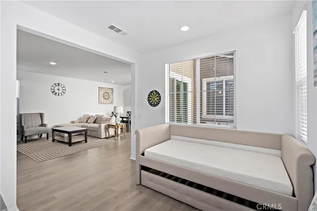 a spacious bedroom with a bed and a window