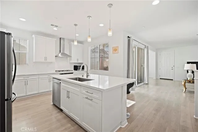 a kitchen with a sink appliances and cabinets