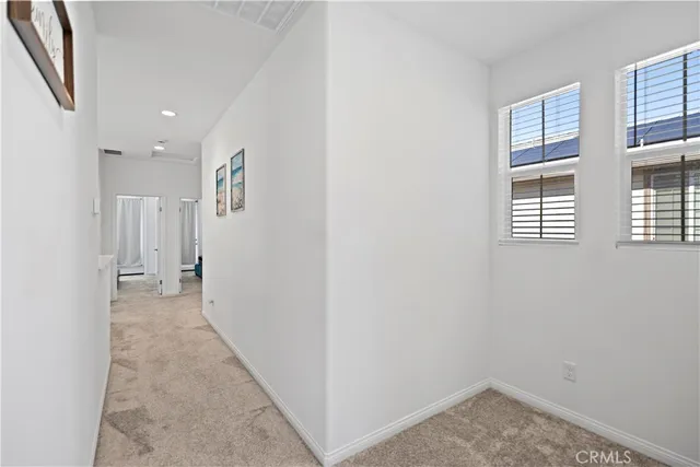 a view of a hallway with closet and cabinet