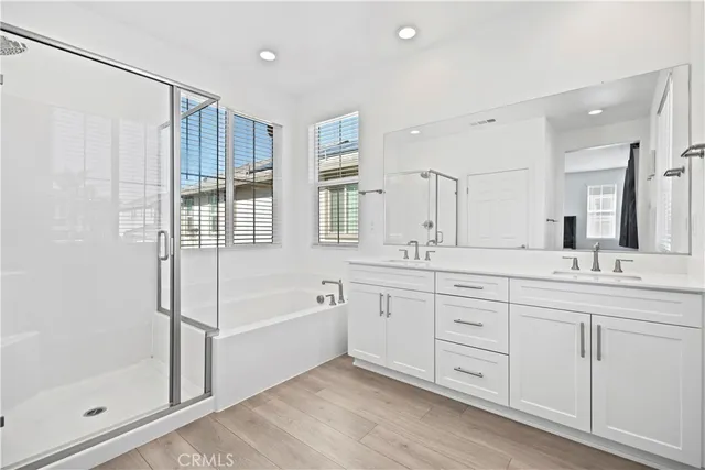 a spacious bathroom with a shower and a tub
