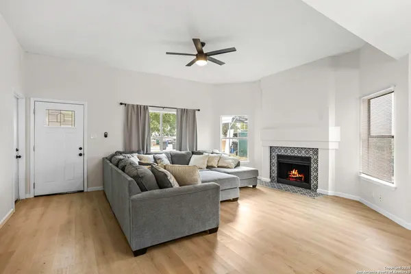 a living room with furniture and a fireplace