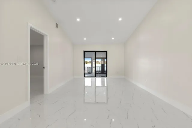 an empty room with windows and closet