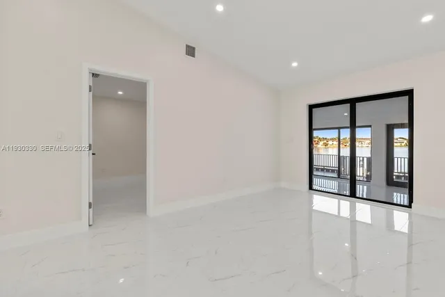 an empty room with windows and closet