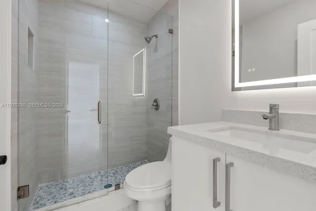 a bathroom with a glass shower door