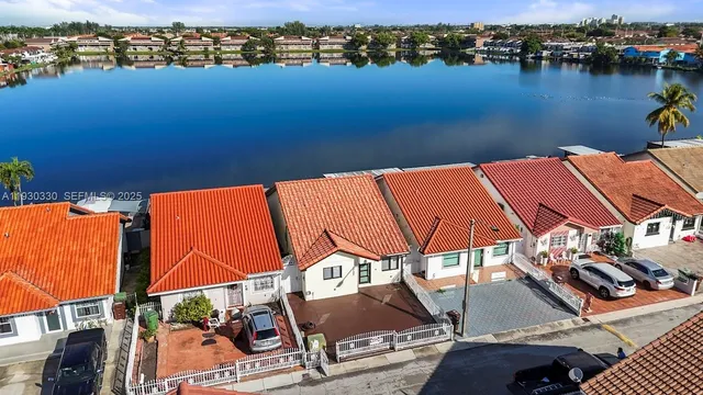 an aerial view of a house with a lake view